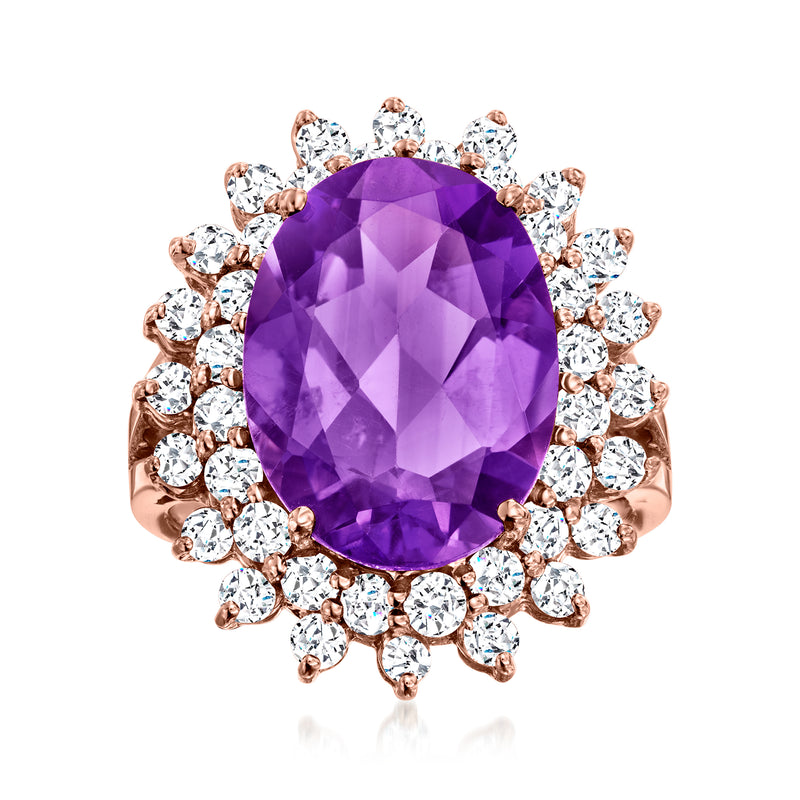 Oval amethyst centerpiece with round diamond halo in rose gold ring