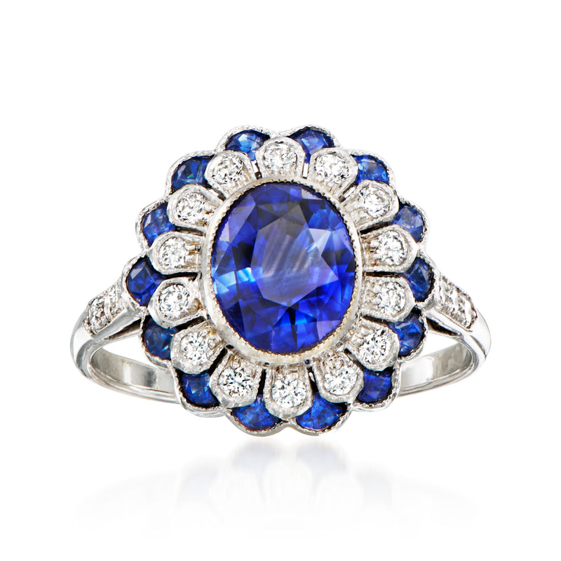 Vintage floral sapphire and diamond ring with oval blue center in white gold