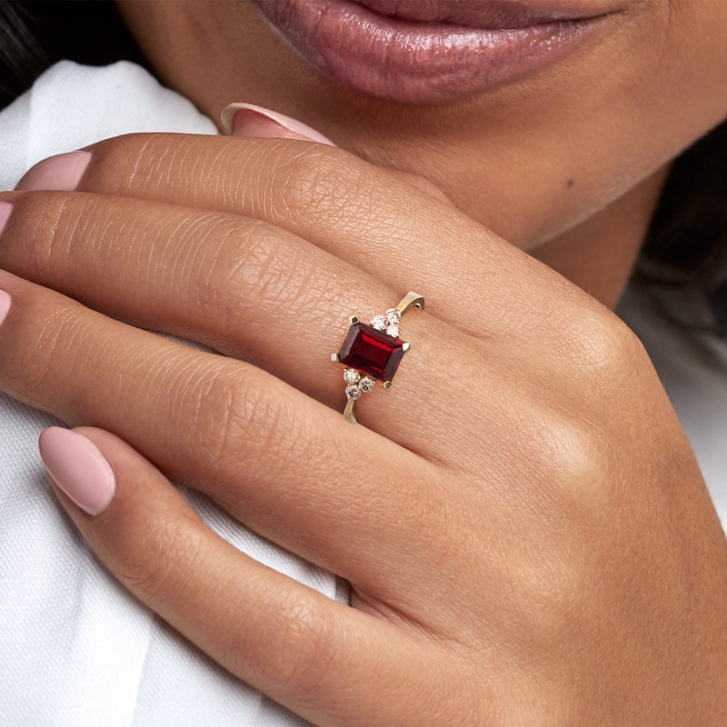 14kt yellow gold garnet ring with emerald-cut red stone and diamond accents