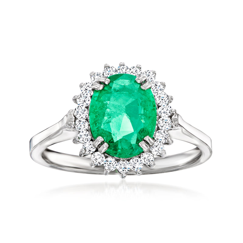 Emerald green oval ring with diamond halo and split white gold band