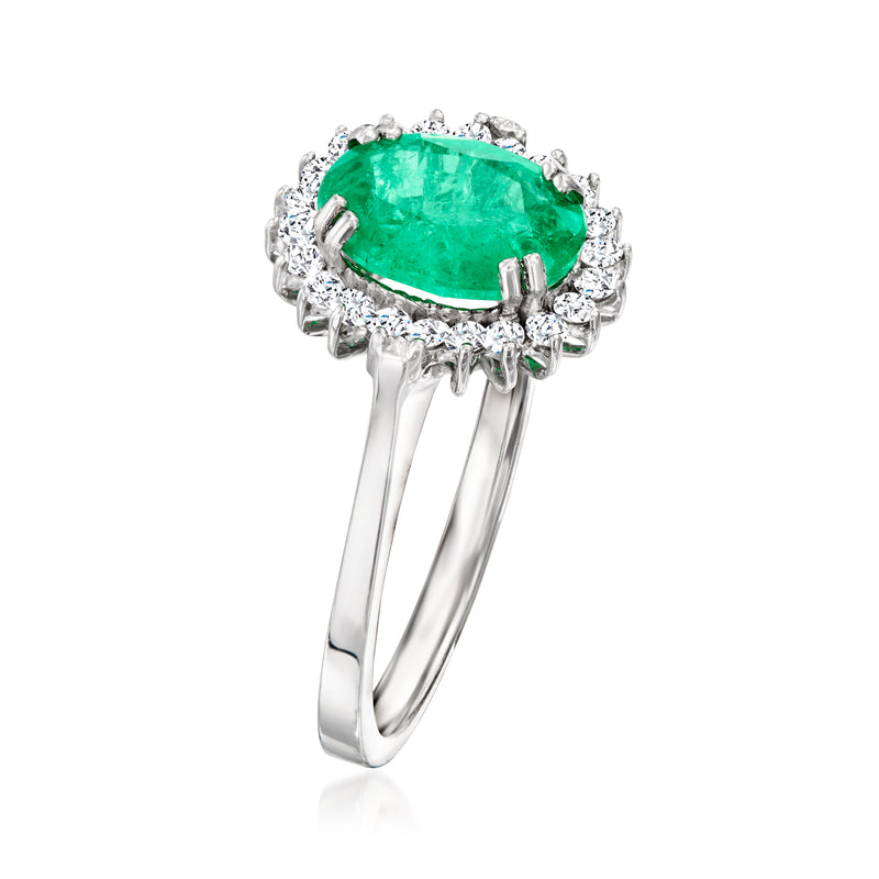 Emerald green oval center with diamond cluster halo, white gold ring