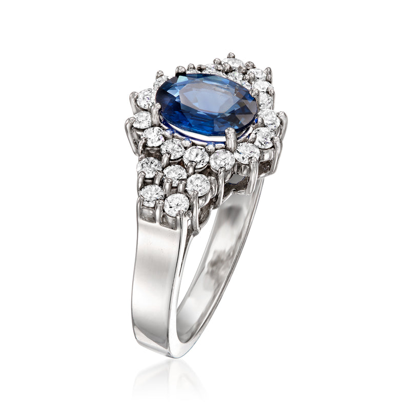 Side view: oval blue sapphire with diamond halo, prong-set white gold ring