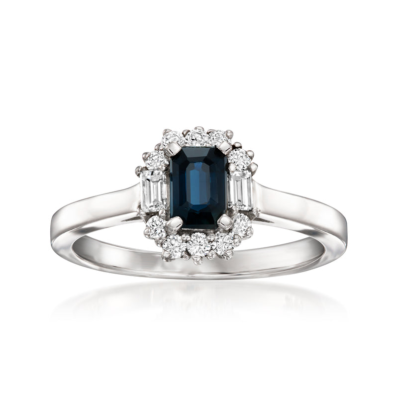 White gold ring with dark blue sapphire center and diamond halo, cushion-cut