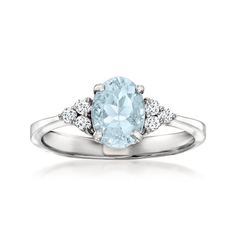14kt white gold ring with oval aquamarine center and small diamond side clusters