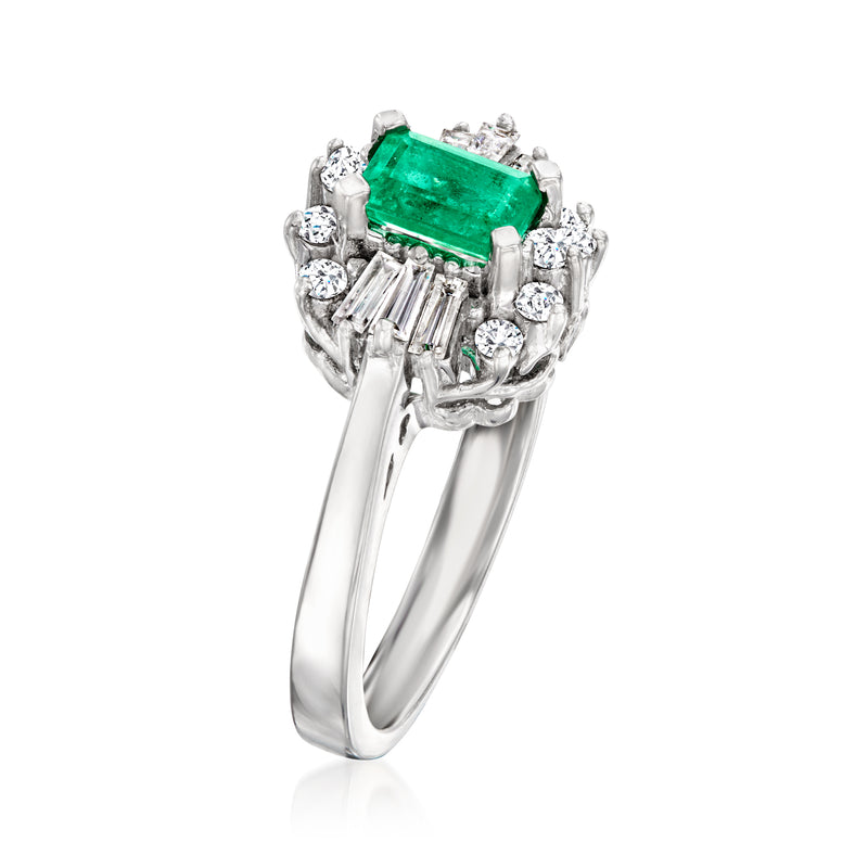 Side view of emerald-cut green gemstone ring with diamond halo and white gold band