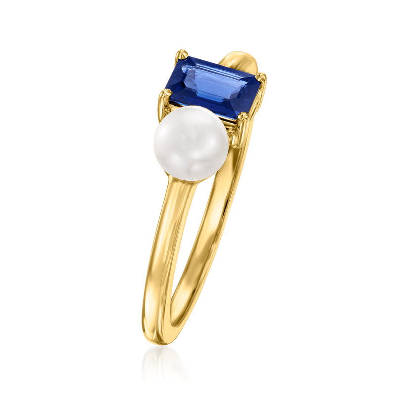 Yellow gold ring featuring round white pearl and blue sapphire in square setting