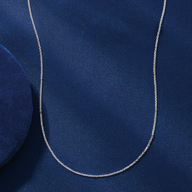 Platinum-toned 1mm cable-chain necklace worn on the neck, fine interlocking links
