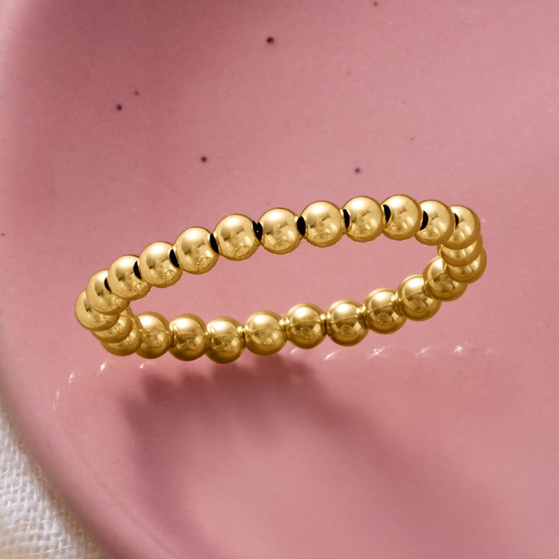 14kt yellow gold bead stretch ring close-up of glossy round beads