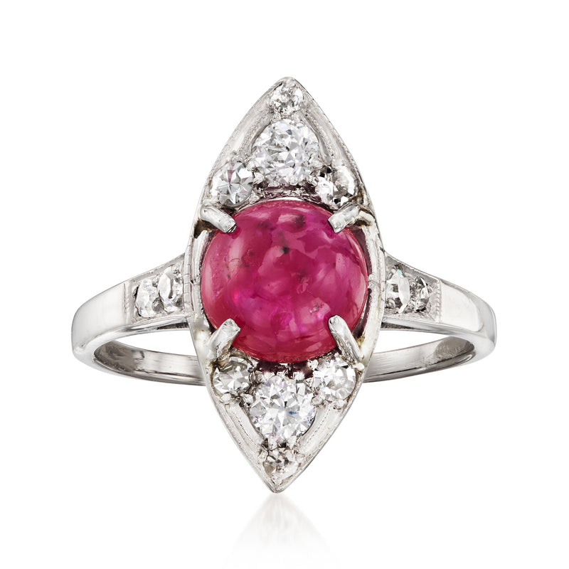 Platinum navette ring with oval pink-red ruby center and diamond halo accents