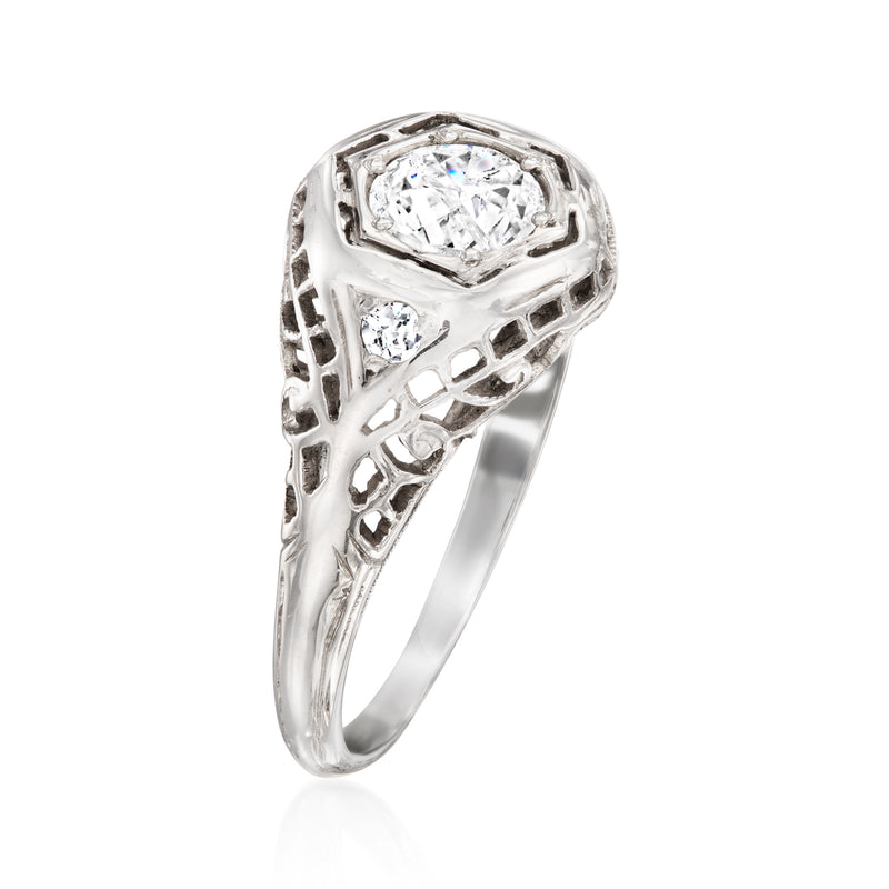 White gold diamond filigree ring with round center stone and openwork shoulders