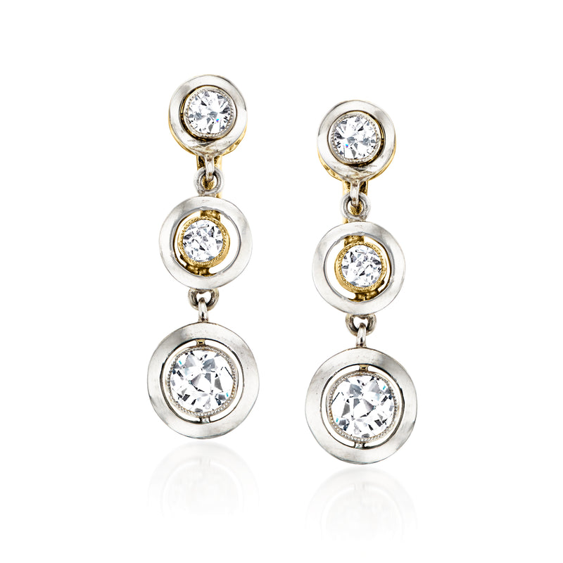 Vintage diamond drop clip earrings with three round stones in platinum-tone settings