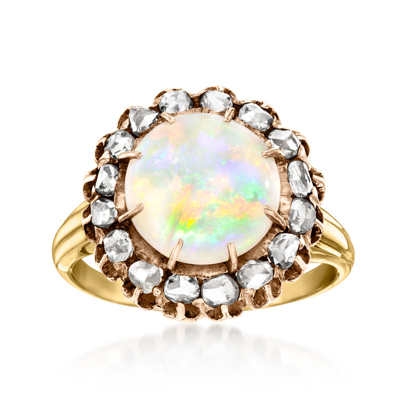 Two-tone gold ring with oval opal cabochon and halo of round diamonds