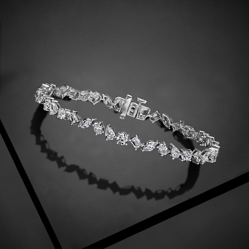 Multi-shaped diamond tennis bracelet in 14kt white gold, angled side view