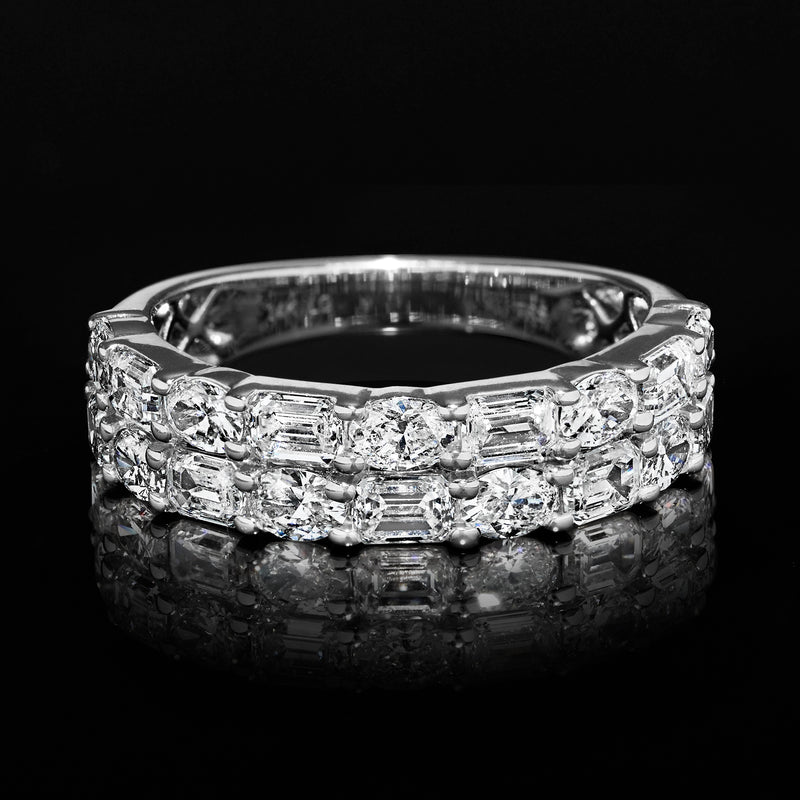 Wide white gold diamond ring with alternating oval and emerald-cut stones, front view