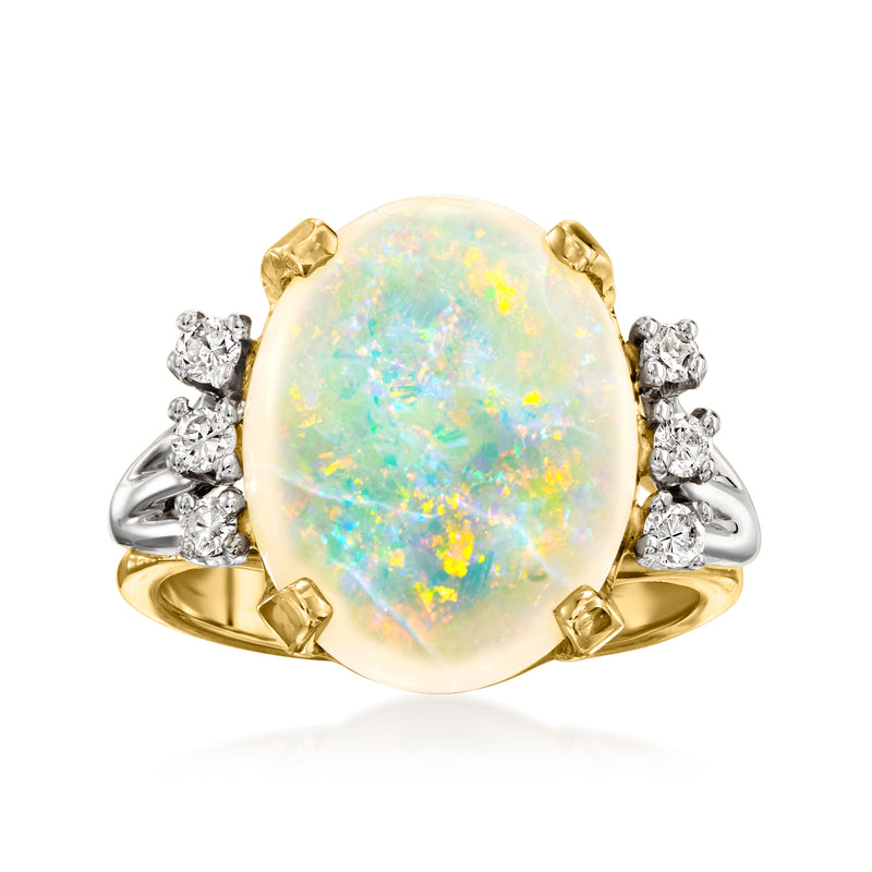 Oval opal two-tone gold ring with round diamond accents on side prongs