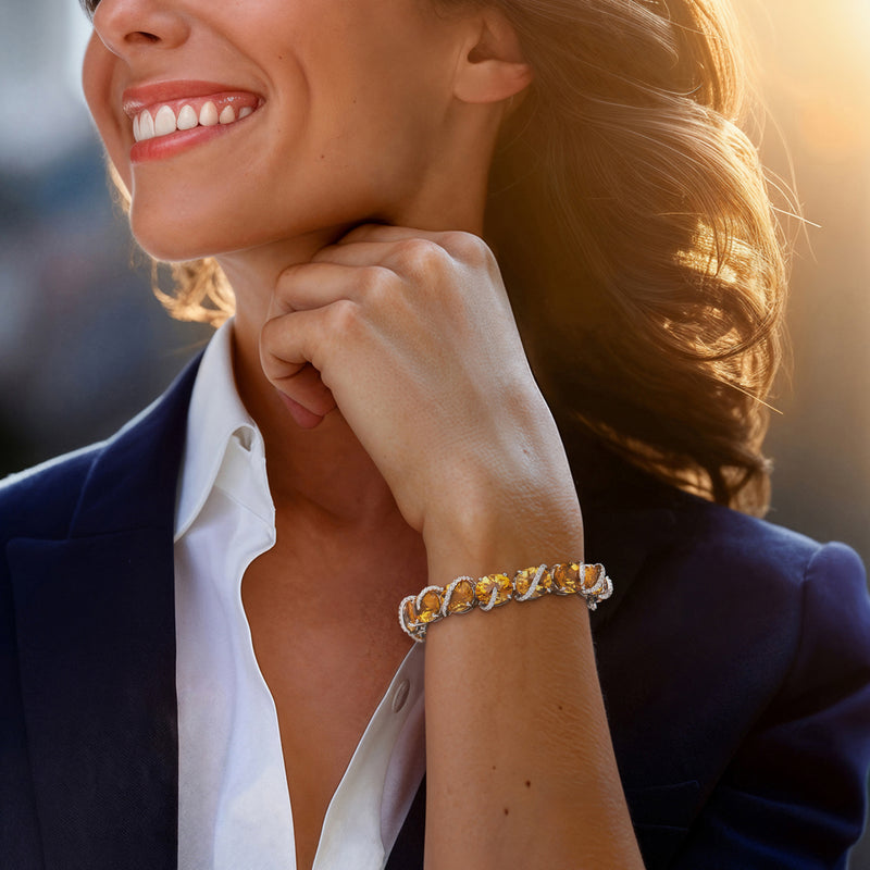 Citrine and diamond link bracelet on wrist with oval yellow stones and white accents