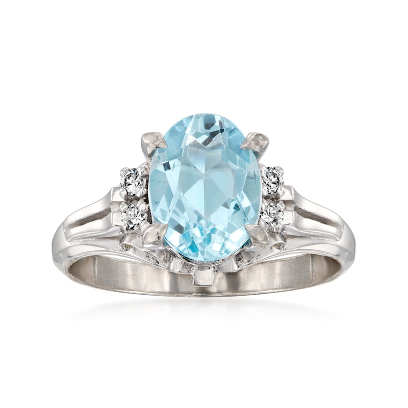 Platinum ring with large oval aquamarine center stone and diamond side accents