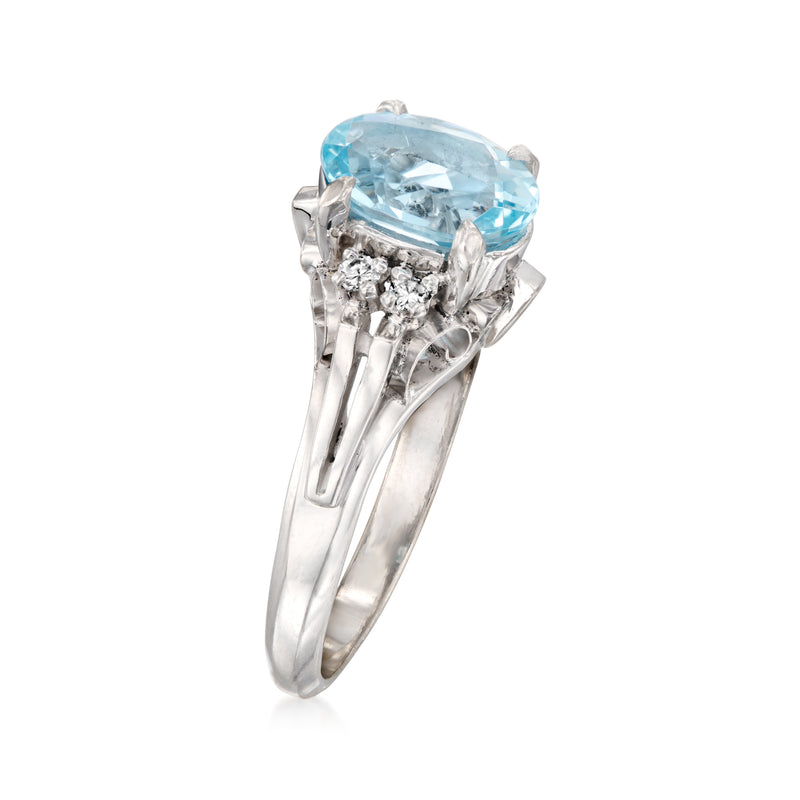 Platinum aquamarine ring with oval blue stone, diamond accents and prong setting