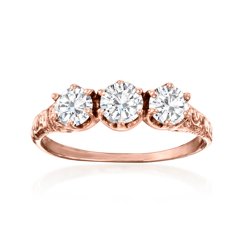 Rose gold diamond ring with three round stones in a vintage setting