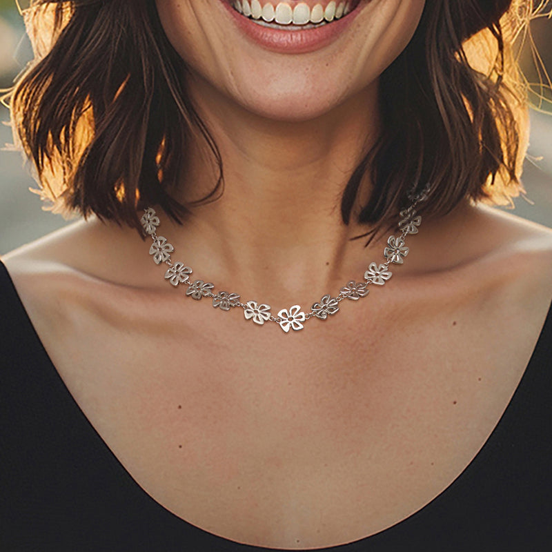 Sterling silver flower necklace with small layered blossoms on a V-neckline