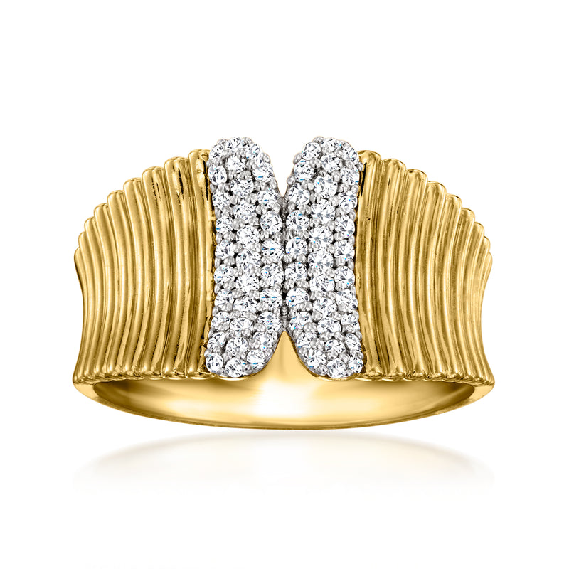 Ribbed gold ring with oval diamond cluster centerpiece and split band design.