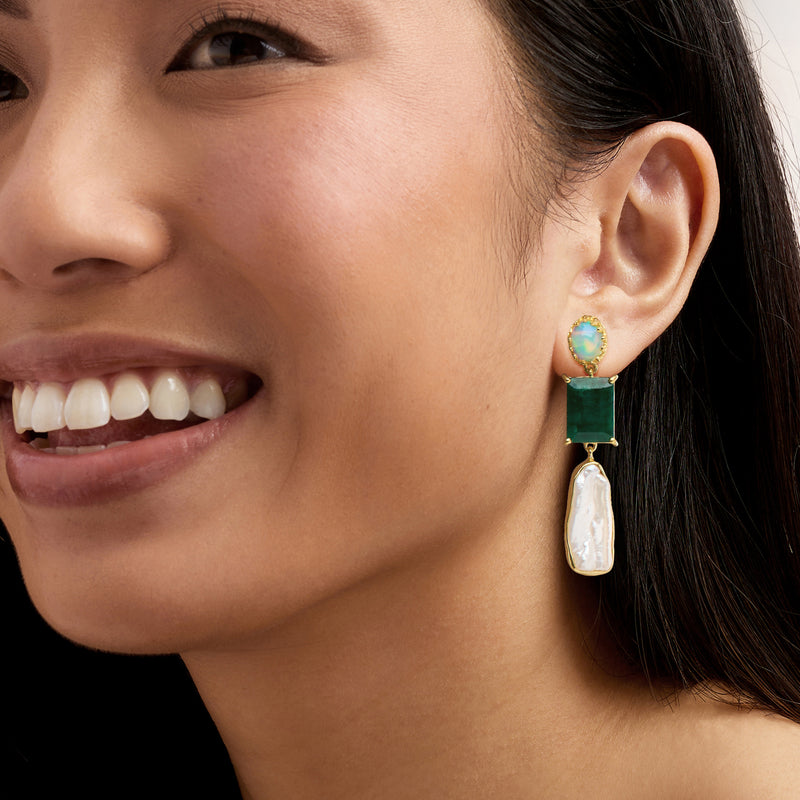 Gold drop earrings with emerald-green and opal-like accents, topped with baroque pearl