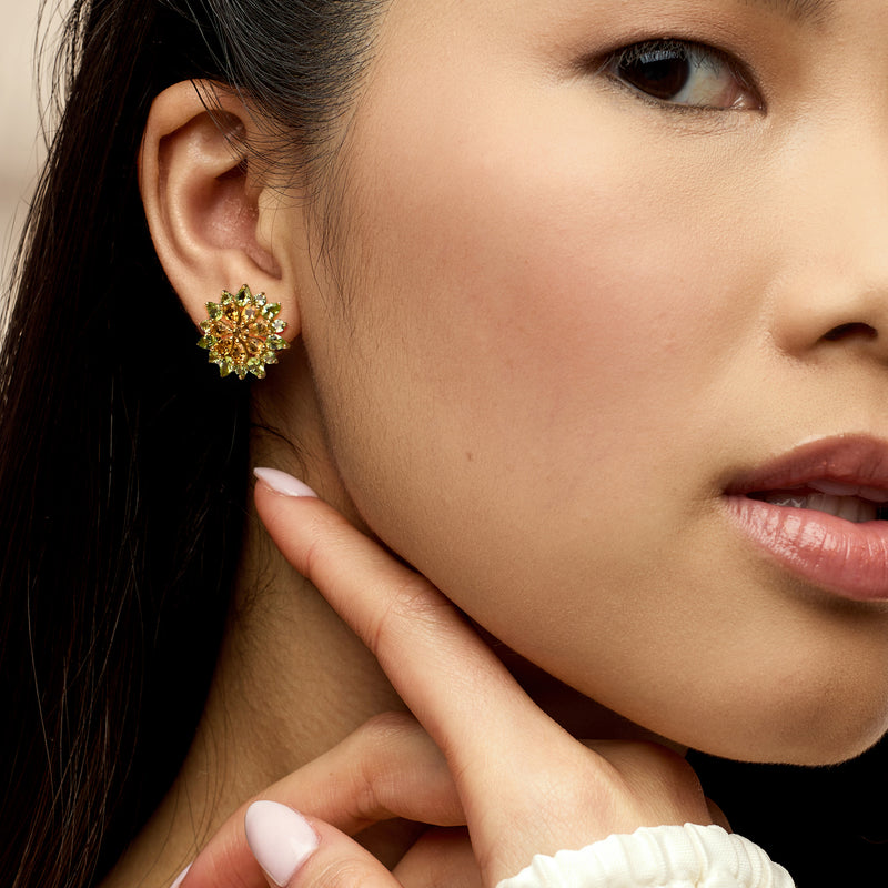 Floral post earrings in gold with green peridot and yellow citrine center flower.