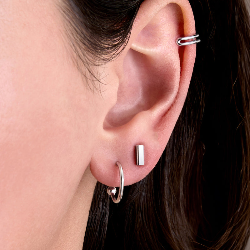 Sterling silver ear with double-row cuff, rectangular bar stud, and small hoop earring