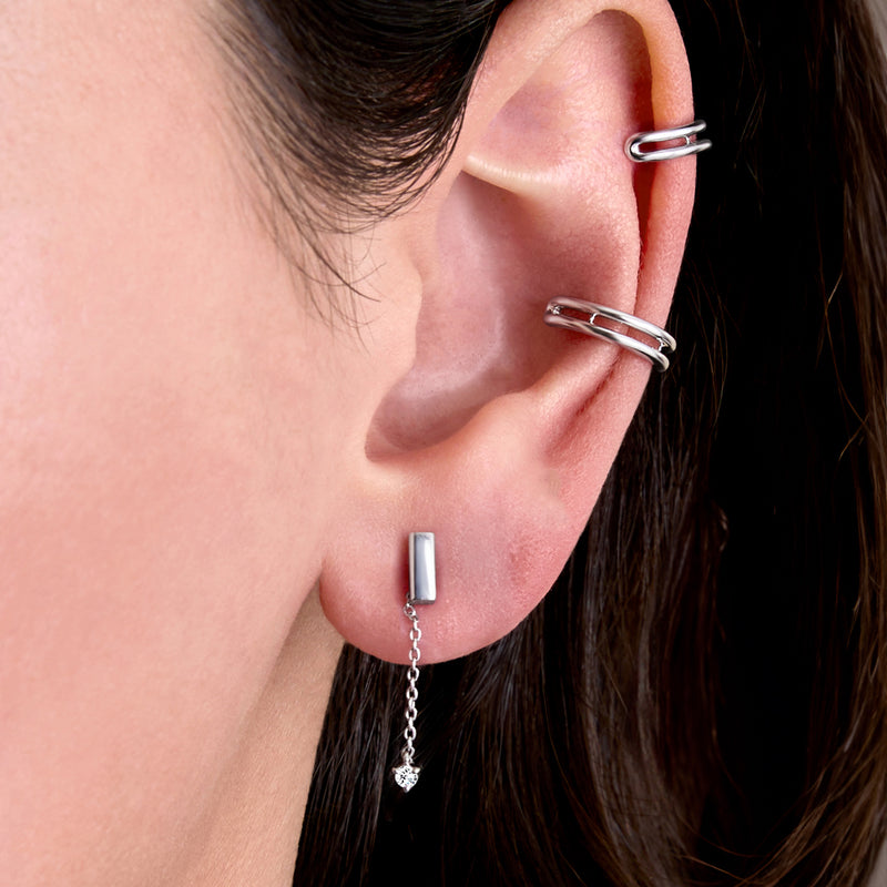Sterling silver ear with double-row cuff, rectangular bar stud, and dangling chain charm