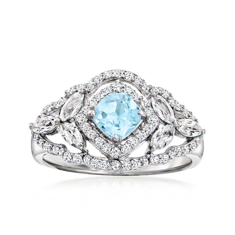 Sterling silver ring with sky blue oval topaz center and white gemstone halo and side accents