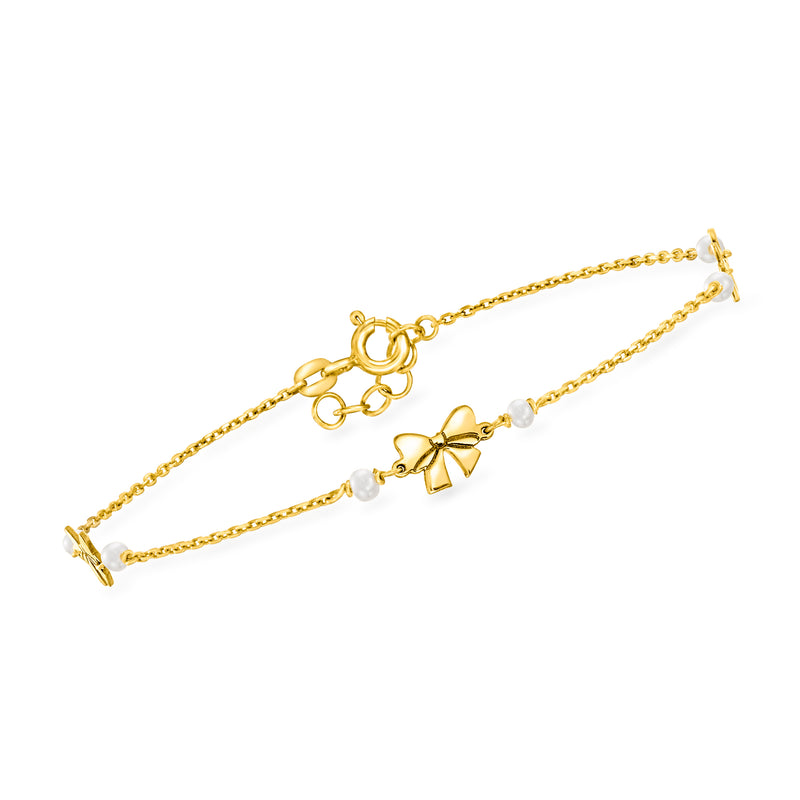 14kt yellow gold bracelet with bow charm and small cultured pearls along the chain