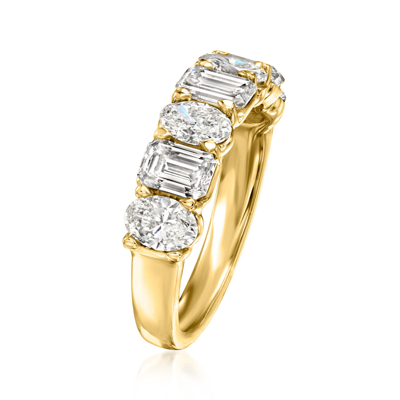 Side view of 14kt yellow gold ring with oval and emerald-cut lab diamonds, prongs