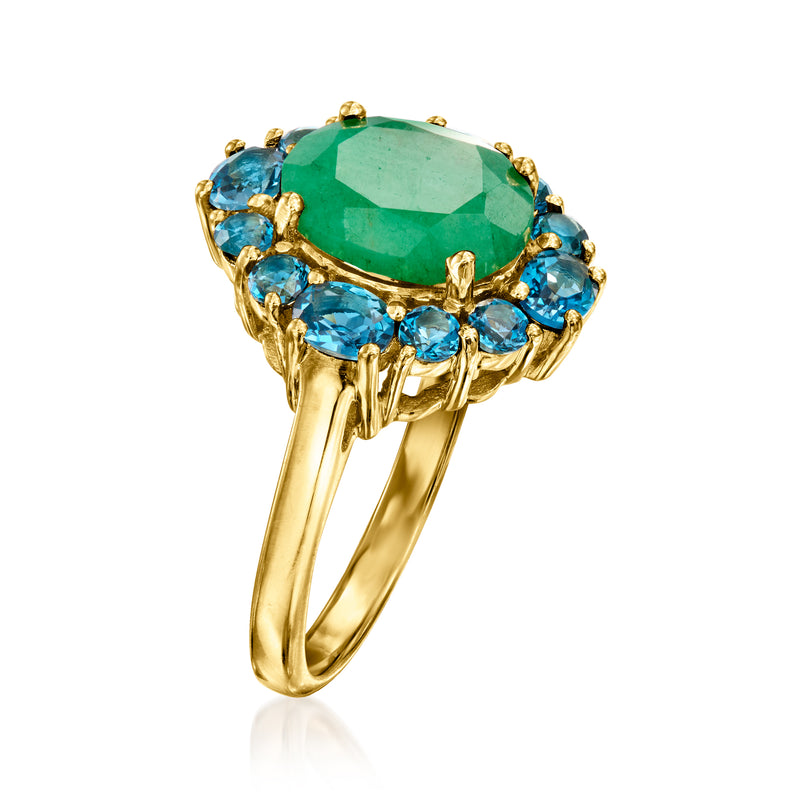 Gold emerald-green oval ring with blue topaz side stones on a split halo setting