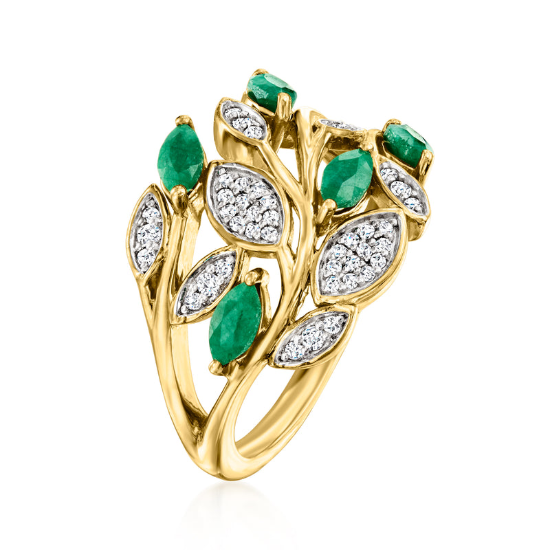 Gold leaf ring with multiple green gemstones and white marquise-style crystal centers.