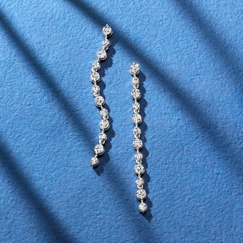 14kt white gold linear drop earrings with round diamonds in a vertical line