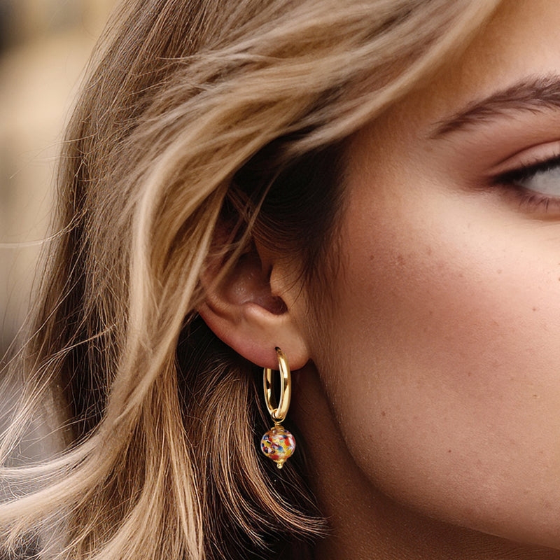 Model wearing gold over sterling hoop earrings with multicolor orb drop