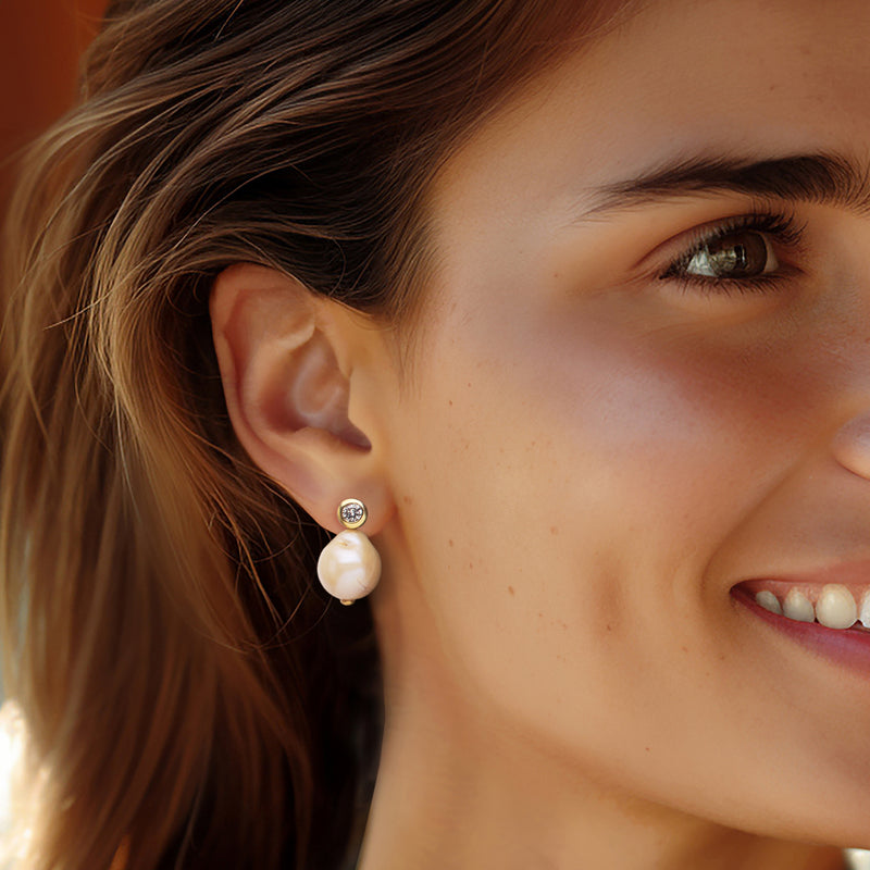 Gold drop earrings with pearl drops and small CZ top detail on ear