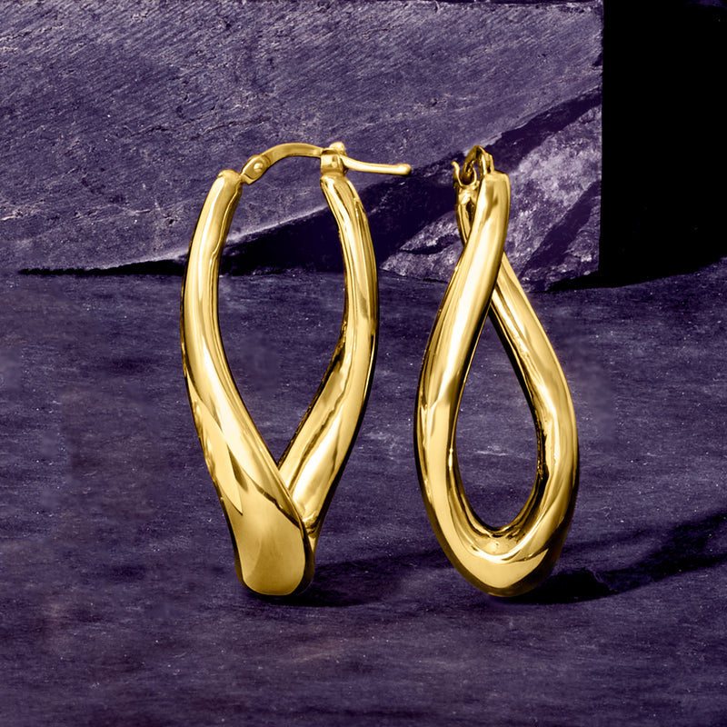 Twisted yellow gold hoop earrings with curved teardrop profile