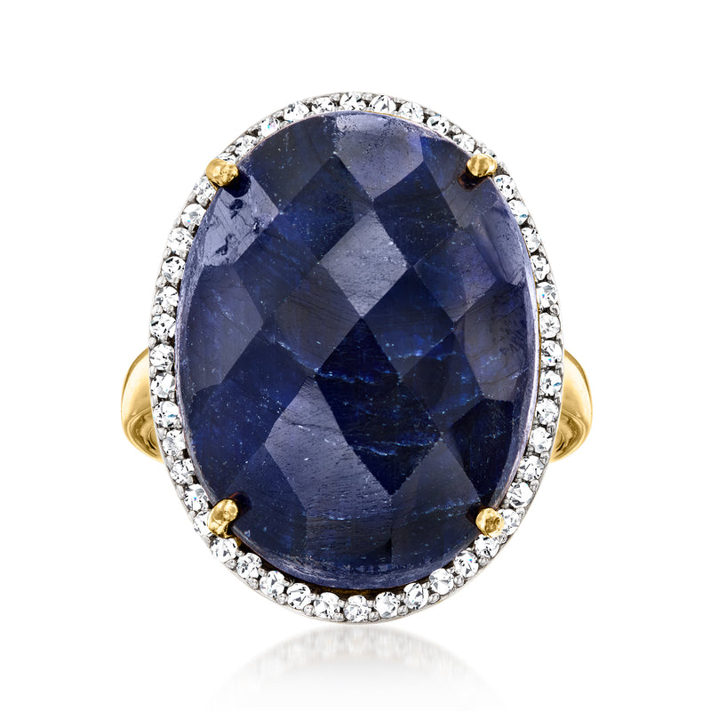Oval sapphire ring in 18kt gold over sterling with white stone halo and prong-set blue gem