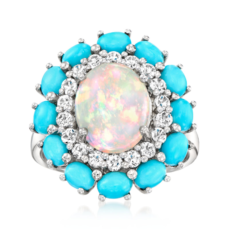 Sterling silver ring with oval opal center, round white stones halo, and blue oval accents