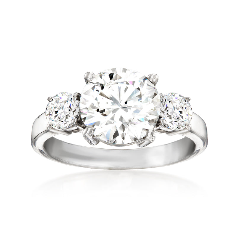 White gold three-stone diamond ring with large round center and two round side stones