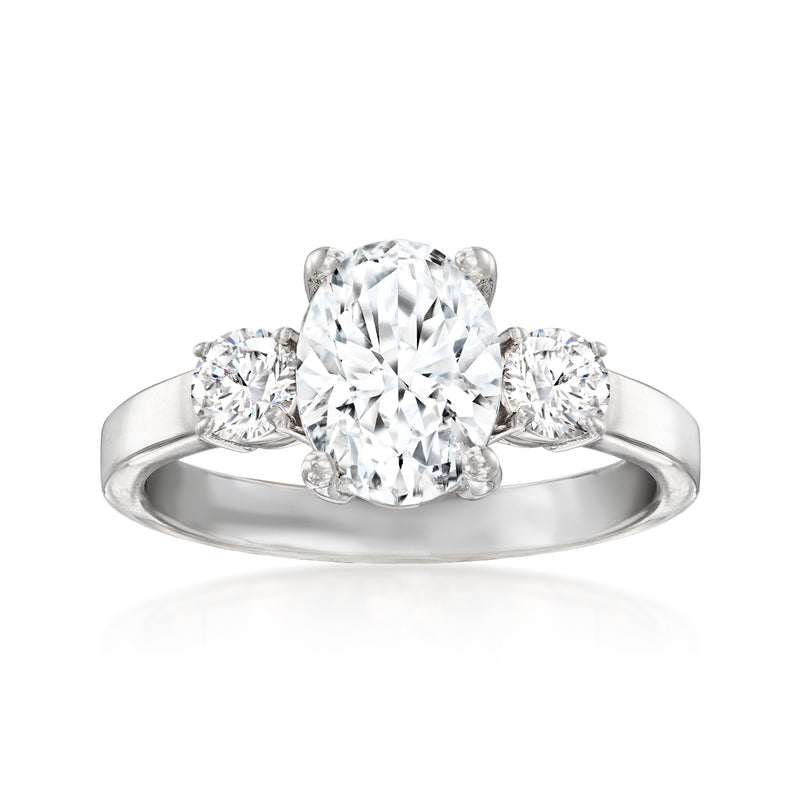 14kt white gold three-stone diamond ring with large round center and two side round stones