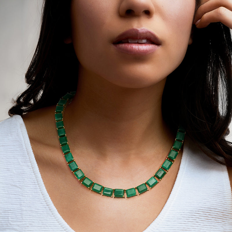 Green emerald-style stone necklace with gold bezel links at neckline