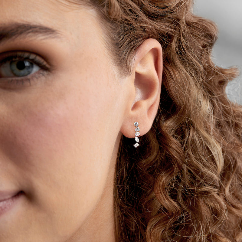 White gold drop earrings with clustered diamond shapes and baguette accents