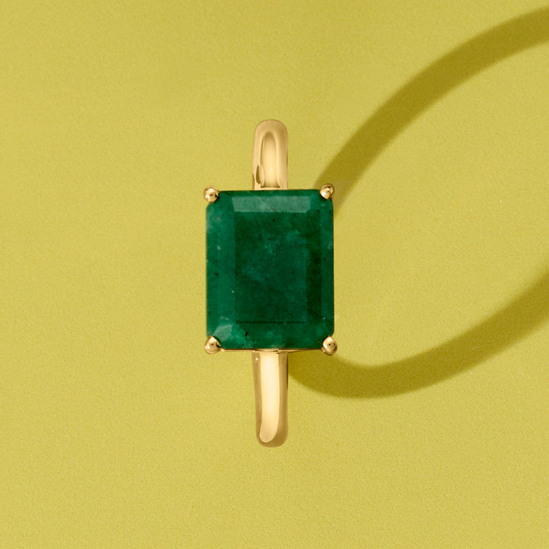 Minimal gold prong ring with emerald-green rectangle stone, top view