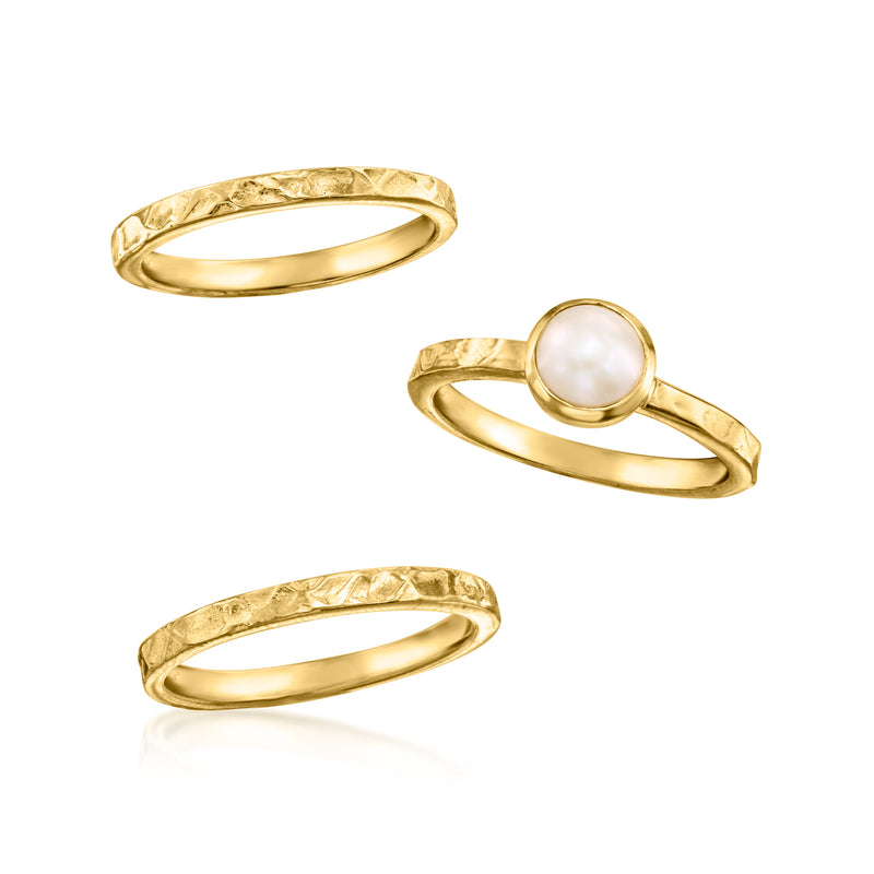 Three gold stackable rings with one round white pearl and two plain bands