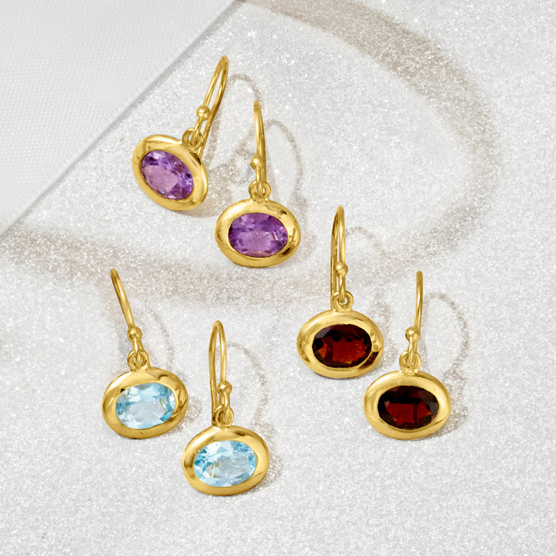 Three-pair gold drop earring set with purple, blue, and red round gemstones