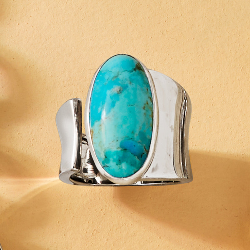 Sterling silver wrap ring with oval turquoise stone, high-set open frame