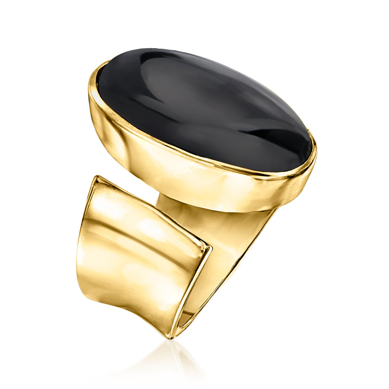 Gold-tone oval onyx wrap ring viewed from the side, glossy black stone in bezel
