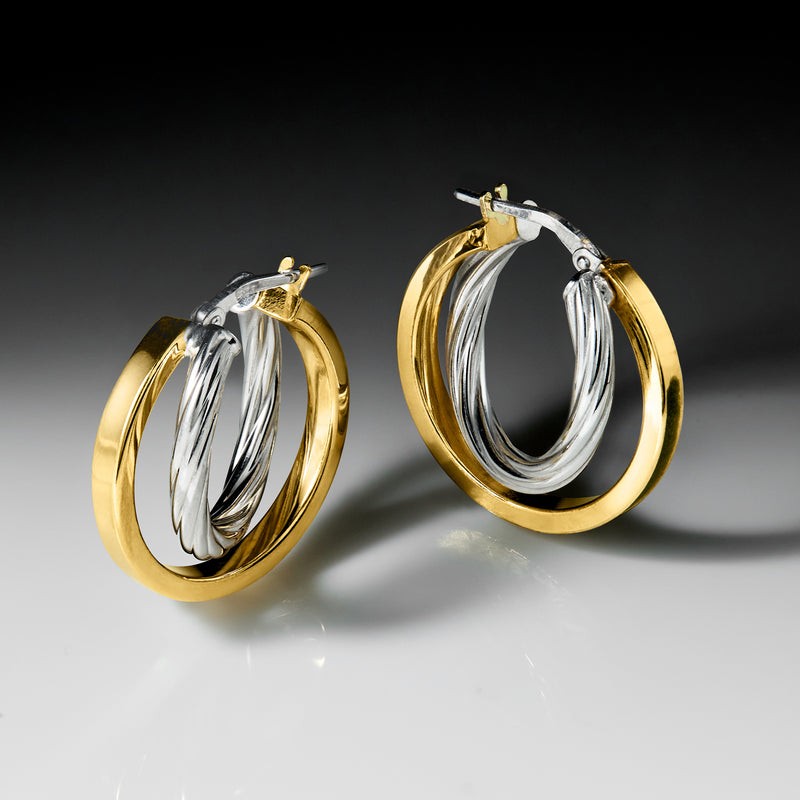 Gold-tone and silver two-tone double hoop earrings with hinged clasp